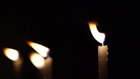 Footage of light from candles in the dark and bokeh of candles