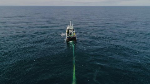 The Barents Sea.Russia.July 2019.Trawler in the sea. View from above. Aerial video.Trawler lifts the trawl.