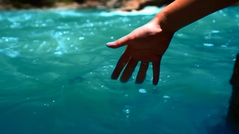 the hand falls into the blue mountain river