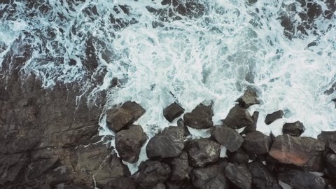 Aerial view of the sea waves crashing on rocks with foam and splash Beautiful Transition