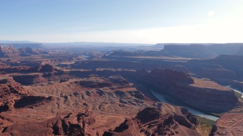 Panorama of picturesque famous grand canyon of Colorado river with red sandstone rocks in light of sunset. Deadhorse national park, popular tourist destination. View from height of observation point