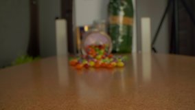 Pan over round candy sweets on a wooden table. Close up macro view of the colorful candies. - Powered by Shutterstock - Get 15% off with code: PIKWIZARD15