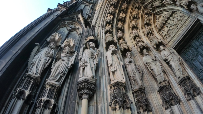 The entrance of the Cologne Cathedral (Kolner Dom), Roman Catholic cathedral, located in the city of Cologne, Germany, shows the 19th century decoration. Marble figures of saints on the facade.