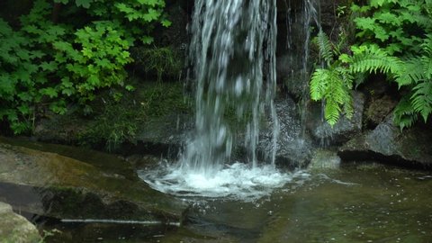 
waterfall with clear natural water on a small stream in the jungle. falling water drops