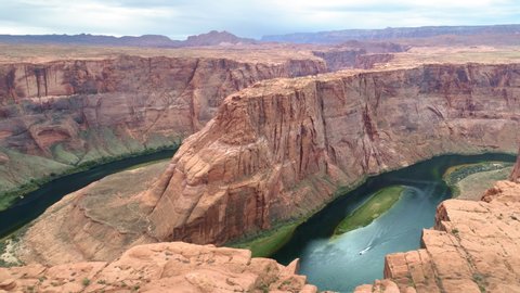 4K aerial world famous tourist attraction - Horseshoe bend canyon, Arizona. Cinematic American Wild West wilderness nature. Aerial red cliffs over Colorado river. USA travel and road trip footage