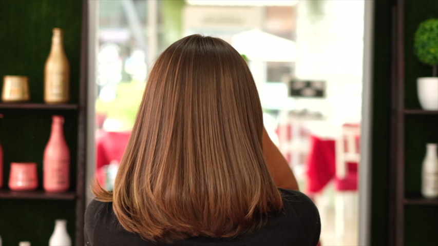 A client after keratin bonding hair straightening in beauty salon.	  | Shutterstock HD Video #1056072245