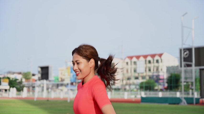 Asian women walk and run on the track in the running track.