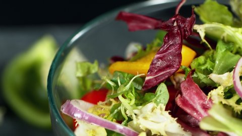 Closeup of super slow motion of falling fresh salad with camera motion. Filmed on high speed cinema camera, 1000fps.