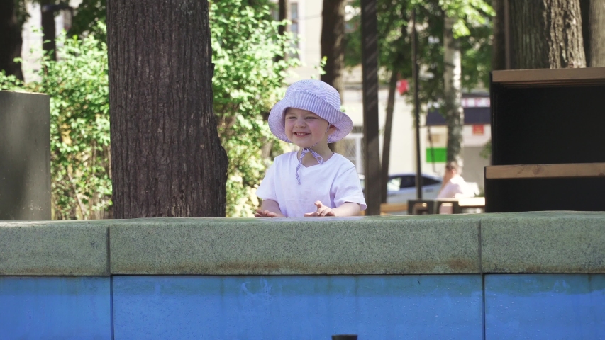 Boy near the fountain in the city park