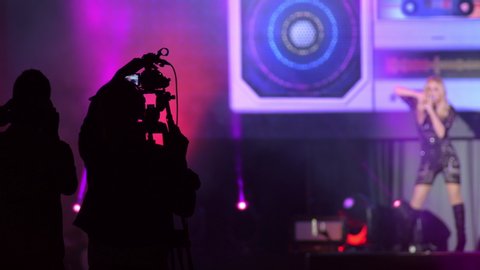 Camera operator working in a pop live concert