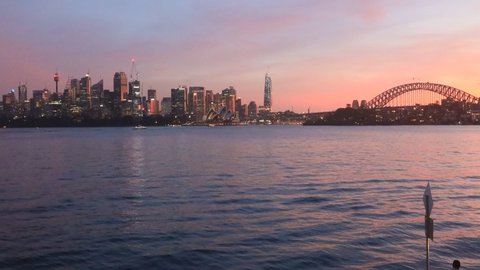 Sunset in Sydney city across harbour – major CBD landmarks 4k time lapse.
