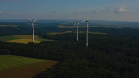Aerial view of wind turbines close to Berlichingen in Germany. On a late afternoon under a cloudy sky in spring