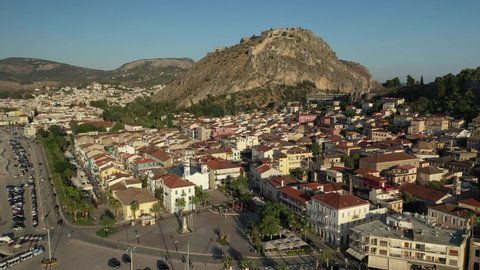 Aerial drone video of historic and picturesque seaside old town of Nafplio and famous Palamidi castle at the background, Argolida, Peloponnese, Greece