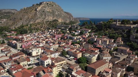 Aerial drone rotational video of historic and picturesque seaside old town of Nafplio and famous Palamidi castle at the background, Argolida, Peloponnese, Greece