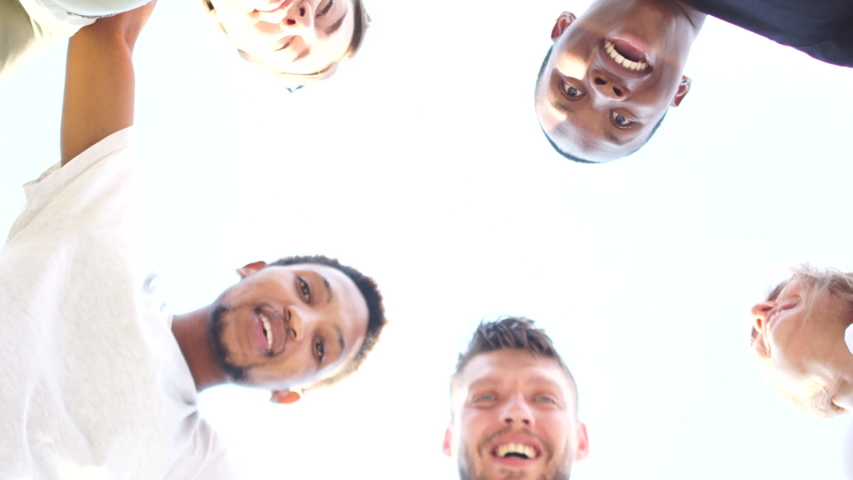 Close portrait of five young students, tolerance and no racism concept. Interracial group of students leaned over the camera against the sky Royalty-Free Stock Footage #1056095429