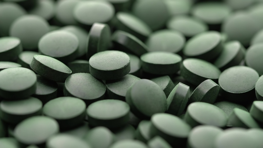 rotating Spirulina, chlorella supplement pills close up, macro shot Royalty-Free Stock Footage #1056095600