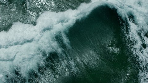 Vitality of blue energy and clear ocean water. Powerful stormy sea waves in top-down drone shot perspective.  Crashing wave line in Open Atlantic sea with foamy white texture.