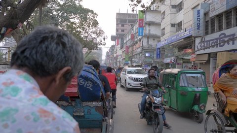 Dhaka, Bangladesh - February 9, 2019: Taking a Rickshaw ride through the streets of Dhaka, Bangladesh in the evening.