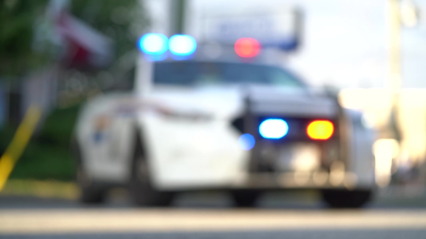 Vancouver, British Columbia, Canada. Blurred out police cruiser interceptor car flashing the lights at a crime scene.  Royalty-Free Stock Footage #1056105809