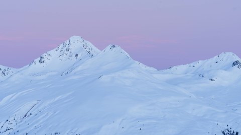 Plessur Alps snow mountain at sunrise, light and shadow moving on snow, time-lapse, Davos in Switzerland