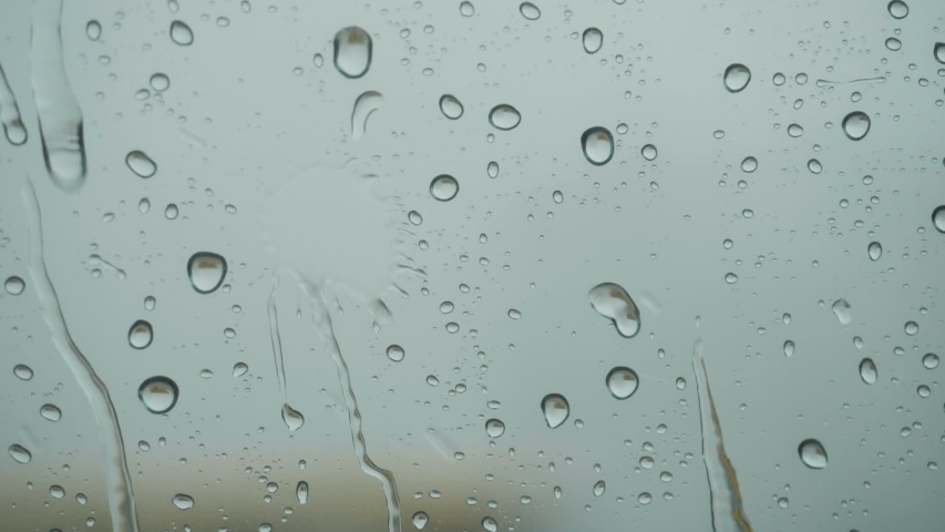 Rain On Glass Of Window With Outside. Close Up. Slow Motion. Rain On Glass. Rain Drops Water On Car Window Background. Bad Weather Autumn. 