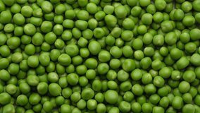 fresh green peas rotating close up, top view