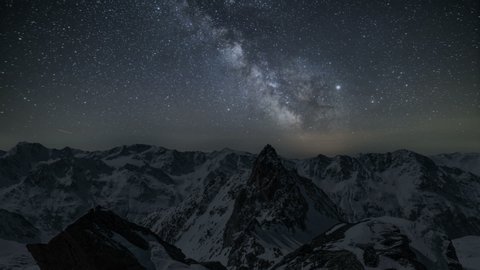 Beautiful starry night sky with milky way galaxy stars over winter alps mountains