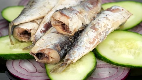 rotating sardines with cucumber and red onion 
