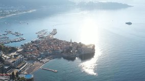Budva, Montenegro. Drone footage in the summer morning. View of the Saint Ivan Church and old town. Adriatic coast, in the Mediterranean.