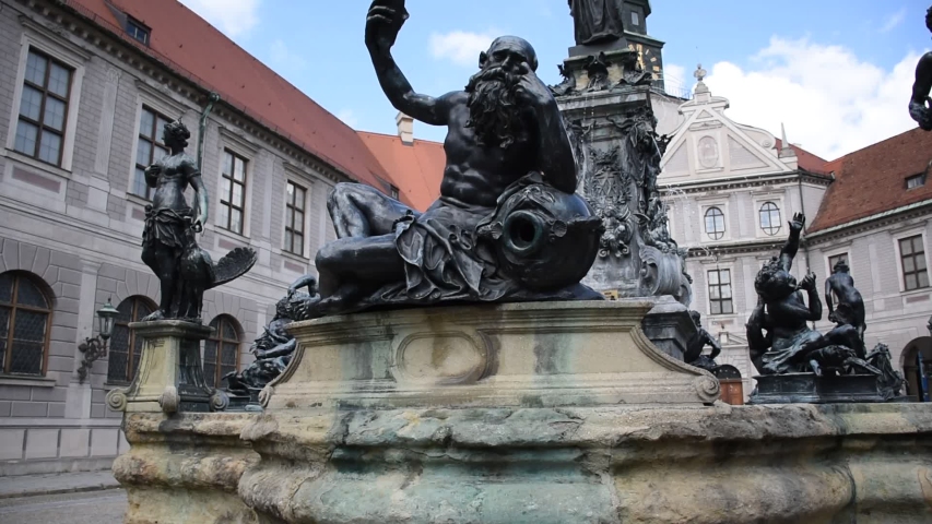 Octagonal yard called Fountain Courtyard (Brunnenhof) is one of the ten courtyards of the Residenz Palace. The bronze Wittelsbach Fountain in the middle was erected in 1610 Royalty-Free Stock Footage #1056125183
