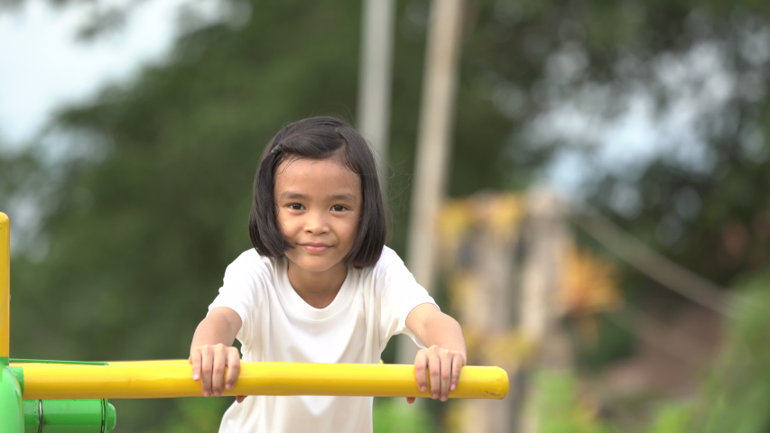 Kids playing and exercing on public outdoor gym park