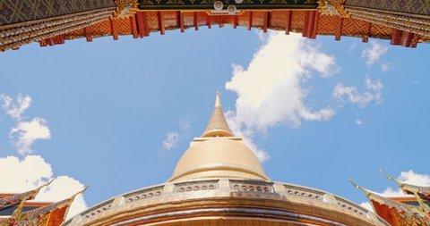 Pagoda of Wat RatchaBophit Buddhist royal temple of Bangkok Thailand looking up with blue sky. Beautiful temple travel in Thailand concept.