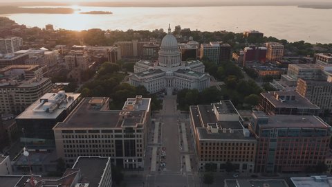 Aerial overhead view of street leading to Madison city center and capitol building. Warm sunset light at background	