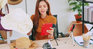 Young Asia girl selling fashion hats and bags on social media by streaming live from her home.