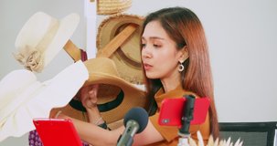 Young Asia girl selling fashion hats and bags on social media by streaming live from her home.