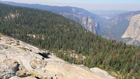 Yosemite National Park at Sentinel Dome summit. Hikers enjoying view of popular El Capitan from Sentinel Dome. Summer travel holidays in California, United States. El Capitan and Half Dome
