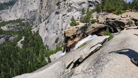 bottom to top view of the Liberty Cap rock and Nevada Fall waterfall on Merced River from John Muir trail in Yosemite National Park. Summer travel holidays in California, United States.