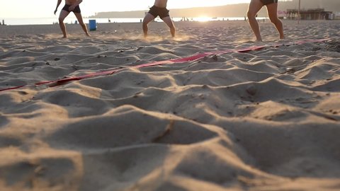 Beach volleyball court on the sandy beach by the sea. Sunny day, sunset sky.
