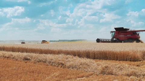 VINNYTSIA, UKRAINE - JULY 19, 2020: Large modern combine harvesters harvest wheat in the field.