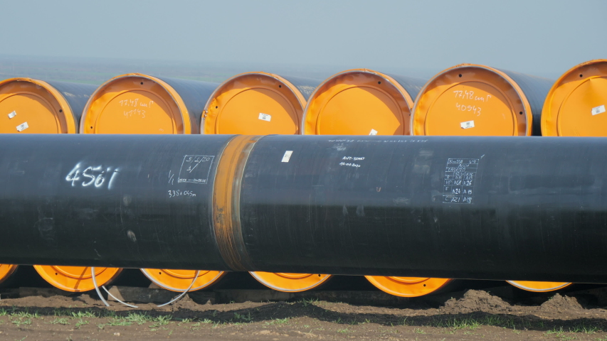 Natural gas pipe line. Pipes welded together, are laid on top of supportive sandbags beside the trench line. Turkish Balkanian Stream to Europe with Russian gas. Royalty-Free Stock Footage #1056154727