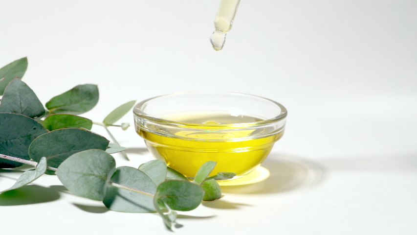 Eucalyptus oil isolated. Eucalyptus oil with leaves on a white background. Cosmetics and aromatic essential oils with eucalyptus extract Royalty-Free Stock Footage #1056155123