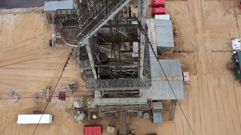 Aerial view. View upwards to work-over and drilling rig. Oil derrick. View from the drilling floor. Oil and gas a land rig, onshore drilling rig