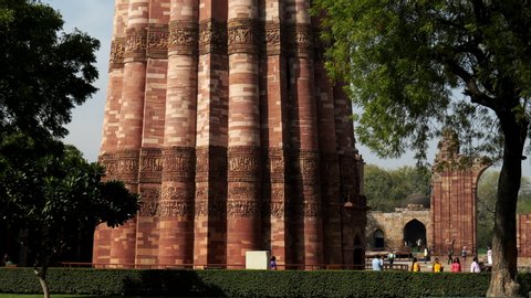 DELHI, INDIA - MARCH 12, 2019: a close tilt up shot of qutub minar tower in delhi, india
