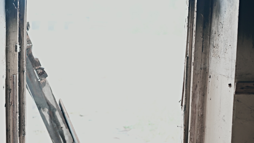 Soldier in full US MARSOC armed with assault rifle run through the abandoned building. Military clash.