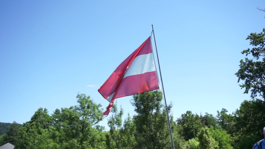 Austrian flag waving in the wind on sunny day Austria