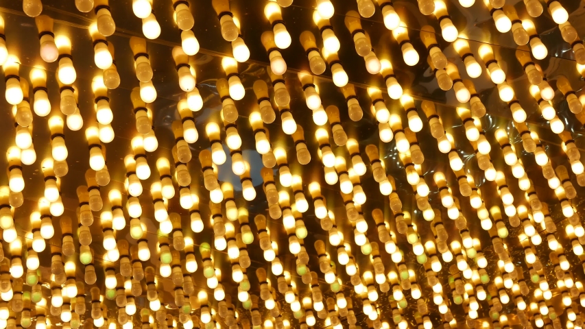 Old fasioned electric lamps blinking and glowing at night. Abstract close up of retro casino decoration shimmering in Las Vegas, USA. Illuminated vintage style bulbs glittering on Freemont street.
