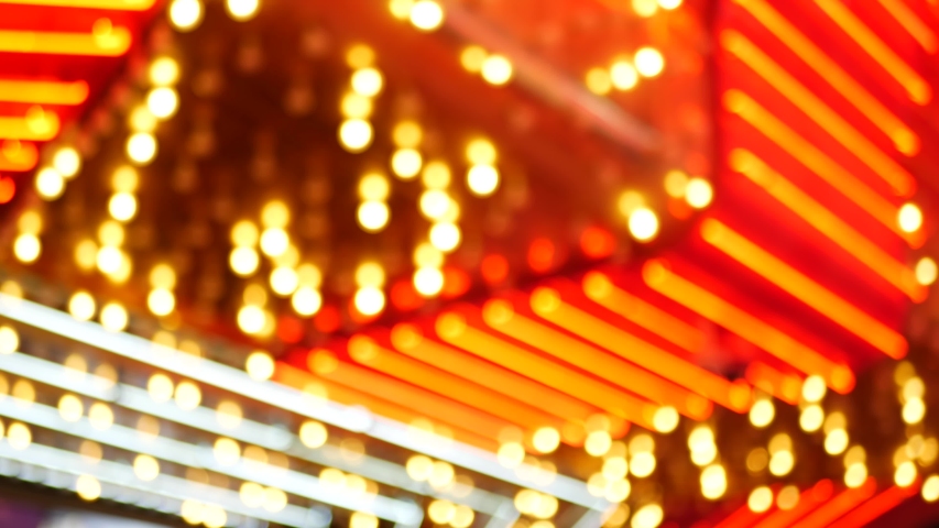 Defocused old fasioned electric lamps glowing at night. Abstract close up of blurred retro casino decoration shimmering, Las Vegas USA. Illuminated vintage style bulbs glittering on Freemont street.