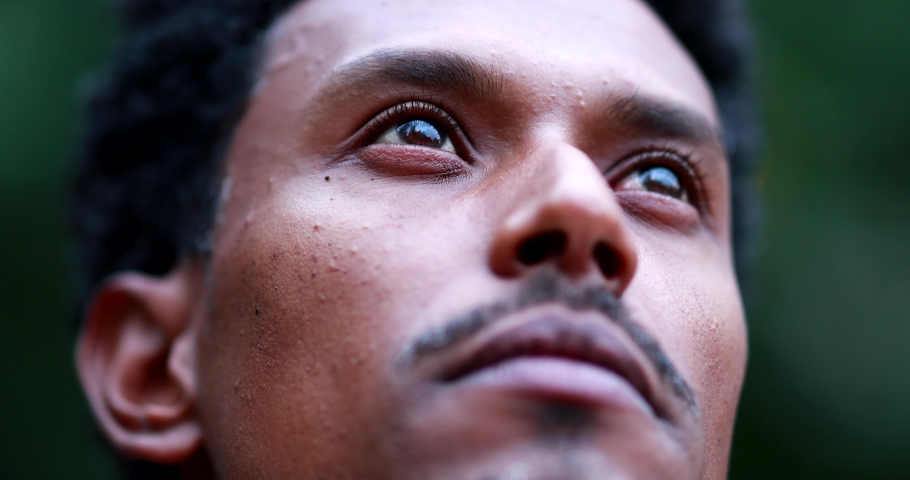 Contemplative man closing eyes. Close-up face portrait of mixed race person meditating outside | Shutterstock HD Video #1056177932