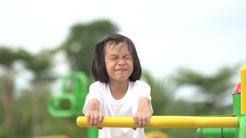 Kids playing and exercing on public outdoor gym park, girl children holding equipment and smile to enjoy play and exercise for good health for outside reaction on blurred background, Asian kids child