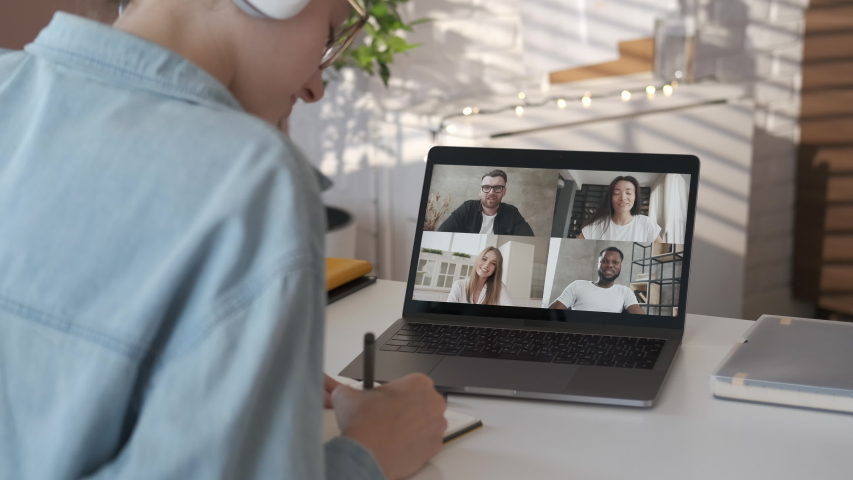 Discussing project online. Group video call. Remote communication of happy multiracial young people. Working from modern home office during pandemic. Business chat conference talking with teacher 4K Royalty-Free Stock Footage #1056187061